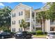 Attractive condo building exterior with car park and staircase leading to upper level units at 601 Hillside Dr. N # 1931, North Myrtle Beach, SC 29582