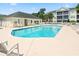 Community swimming pool with lounge chairs and covered picnic area at 601 Hillside Dr. N # 1931, North Myrtle Beach, SC 29582