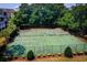 Aerial view of the tennis courts surrounded by trees in a beautiful neighborhood at 601 Hillside Dr. N # 1931, North Myrtle Beach, SC 29582