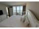 Well-lit bedroom with a view of the ocean from a private balcony at 601 Retreat Beach Circle # 521, Pawleys Island, SC 29585