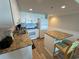 Bright kitchen featuring white cabinets, granite countertops, and modern appliances at 601 Retreat Beach Circle # 521, Pawleys Island, SC 29585