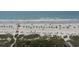 Panoramic aerial view of a lively beach with colorful umbrellas and gentle ocean waves at 6804 N Ocean Blvd. # 1023, Myrtle Beach, SC 29572