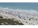 Extensive beach scene with vibrant umbrellas, active beachgoers, and the serene ocean at 6804 N Ocean Blvd. # 1023, Myrtle Beach, SC 29572