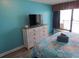 Stylish bedroom boasts a dresser with a television and access to the balcony with an ocean view at 6804 N Ocean Blvd. # 1023, Myrtle Beach, SC 29572