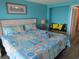 Comfortable bedroom features a queen bed with colorful bedding, accent pillows, and a decorative headboard at 6804 N Ocean Blvd. # 1023, Myrtle Beach, SC 29572