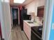 Compact kitchen features stainless-steel appliances and ample counter space; offers view into hallway at 6804 N Ocean Blvd. # 1023, Myrtle Beach, SC 29572