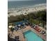 Aerial view of the property showcasing the pool and the beautiful beach beyond at 7100 North Ocean Blvd. # 617, Myrtle Beach, SC 29577