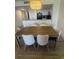 Dining room featuring a large wooden table and seating for six, flowing into the modern kitchen at 7100 North Ocean Blvd. # 617, Myrtle Beach, SC 29577