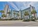 Beautiful exterior view of the condo building with blue accents and tropical landscaping at 7100 North Ocean Blvd. # 617, Myrtle Beach, SC 29577
