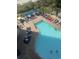 Aerial view of outdoor pool with lounge chairs, blue umbrellas, and people swimming on a sunny day at 7100 North Ocean Blvd. # 617, Myrtle Beach, SC 29577