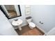 Powder room featuring a pedestal sink, decorative mirror, and stylish fixtures at 7180 Shooting Star Way, Myrtle Beach, SC 29579