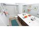 Bright bathroom featuring double sinks, a large mirror, and shower over tub at 7180 Shooting Star Way, Myrtle Beach, SC 29579