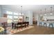 Open concept dining area features hardwood floors, lots of natural light, and a modern chandelier at 7180 Shooting Star Way, Myrtle Beach, SC 29579