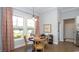 Charming dining area with natural light, wood floors, modern lighting, and beautiful window treatments at 7180 Shooting Star Way, Myrtle Beach, SC 29579