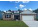 Charming single-story home with stone accents, white garage door, and a well-manicured lawn at 7180 Shooting Star Way, Myrtle Beach, SC 29579