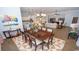 Open living space features hardwood floors, an adjacent dining space, and a view of the kitchen at 7180 Shooting Star Way, Myrtle Beach, SC 29579