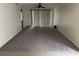 Expansive living room with plush carpeting and sliding glass doors for lots of sunlight at 770 Charter Dr. # C4, Longs, SC 29568
