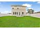 Expansive backyard featuring green lawn, privacy fence, and a small patio with chairs at 79 S Reindeer Rd., Surfside Beach, SC 29575