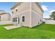 Side view of the backyard showcasing a well-manicured lawn and a small patio at 79 S Reindeer Rd., Surfside Beach, SC 29575