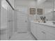 The bathroom features a glass enclosed shower and double sinks with white cabinets at 79 S Reindeer Rd., Surfside Beach, SC 29575