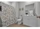 This bathroom includes a floral shower curtain, toilet, vanity and mirror at 79 S Reindeer Rd., Surfside Beach, SC 29575