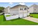 View of the side of the home highlighting the manicured lawn, fenced yard, and attached two-car garage at 79 S Reindeer Rd., Surfside Beach, SC 29575