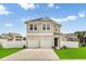 Inviting two-story home featuring double garages, manicured lawn, and charming curb appeal at 79 S Reindeer Rd., Surfside Beach, SC 29575