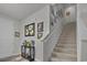 Inviting foyer with carpeted staircase and decorative console table at 79 S Reindeer Rd., Surfside Beach, SC 29575