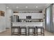 Modern kitchen with bar stool seating, stainless steel appliances, and bright white cabinets at 79 S Reindeer Rd., Surfside Beach, SC 29575