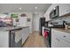 Open concept kitchen with stainless steel appliances, granite countertops, and hardwood flooring at 79 S Reindeer Rd., Surfside Beach, SC 29575