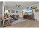 Cozy living room features a comfortable sectional sofa, ceiling fan, and large flat screen television at 79 S Reindeer Rd., Surfside Beach, SC 29575