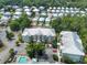 Expansive aerial view of a residential complex with multiple buildings, a pool, and lush green landscaping at 82 Mingo Dr. # 2D, Pawleys Island, SC 29585