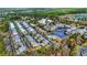 Wide aerial shot of a residential area with houses, a pond, a pool, and surrounding greenery with the ocean visible at 82 Mingo Dr. # 2D, Pawleys Island, SC 29585