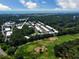 Scenic aerial view of a community near a golf course, featuring lush greenery and a glimpse of the ocean at 82 Mingo Dr. # 2D, Pawleys Island, SC 29585