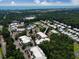 Aerial view showcasing a residential community with a pond, pool, and the distant ocean in the background at 82 Mingo Dr. # 2D, Pawleys Island, SC 29585