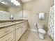 Neutral bathroom featuring granite counters, tiled floor, ample cabinetry, and a combination tub and shower at 82 Mingo Dr. # 2D, Pawleys Island, SC 29585