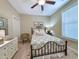Cozy bedroom with ceiling fan, decorative headboard, dresser, and a window providing natural light at 82 Mingo Dr. # 2D, Pawleys Island, SC 29585