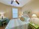 Bright bedroom with ceiling fan, coastal decor, desk, colorful accents, and a window for natural light at 82 Mingo Dr. # 2D, Pawleys Island, SC 29585