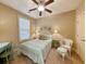 Bright bedroom with ceiling fan, coastal decor, desk, chair and window for natural light at 82 Mingo Dr. # 2D, Pawleys Island, SC 29585