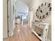 Inviting hallway with wood floors, a decorative table, and a glimpse into the living areas beyond at 82 Mingo Dr. # 2D, Pawleys Island, SC 29585