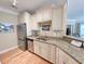 Modern kitchen with stainless appliances, granite counters, bright lighting, and ample cabinet space at 82 Mingo Dr. # 2D, Pawleys Island, SC 29585