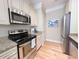 Sleek kitchen featuring stainless steel appliances, granite countertops, and modern fixtures at 82 Mingo Dr. # 2D, Pawleys Island, SC 29585