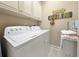 Laundry area with updated washer and dryer, storage, and decorative beach themed decor at 82 Mingo Dr. # 2D, Pawleys Island, SC 29585
