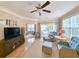 Cozy living room featuring a ceiling fan, balcony access, and comfortable seating area with accent pillows at 82 Mingo Dr. # 2D, Pawleys Island, SC 29585