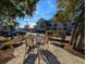 Outdoor seating area with a table and four chairs, barbecue, and view of the condos in the background at 82 Mingo Dr. # 2D, Pawleys Island, SC 29585