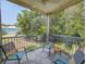 Enclosed porch featuring four chairs, a ceiling fan and an exterior view of a lawn and trees at 82 Mingo Dr. # 2D, Pawleys Island, SC 29585