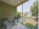 Relaxing porch with chairs, ceiling fan, and view of a pond and community at 82 Mingo Dr. # 2D, Pawleys Island, SC 29585