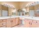 Spacious bathroom featuring a large mirror, double vanity, and warm color tones at 821 Laquinta Loop, Murrells Inlet, SC 29576