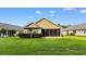 Charming exterior view featuring a screened porch, well-maintained lawn, and simple landscaping at 821 Laquinta Loop, Murrells Inlet, SC 29576