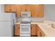 Bright kitchen featuring updated appliances, ample counter space, and wooden cabinets at 821 Laquinta Loop, Murrells Inlet, SC 29576
